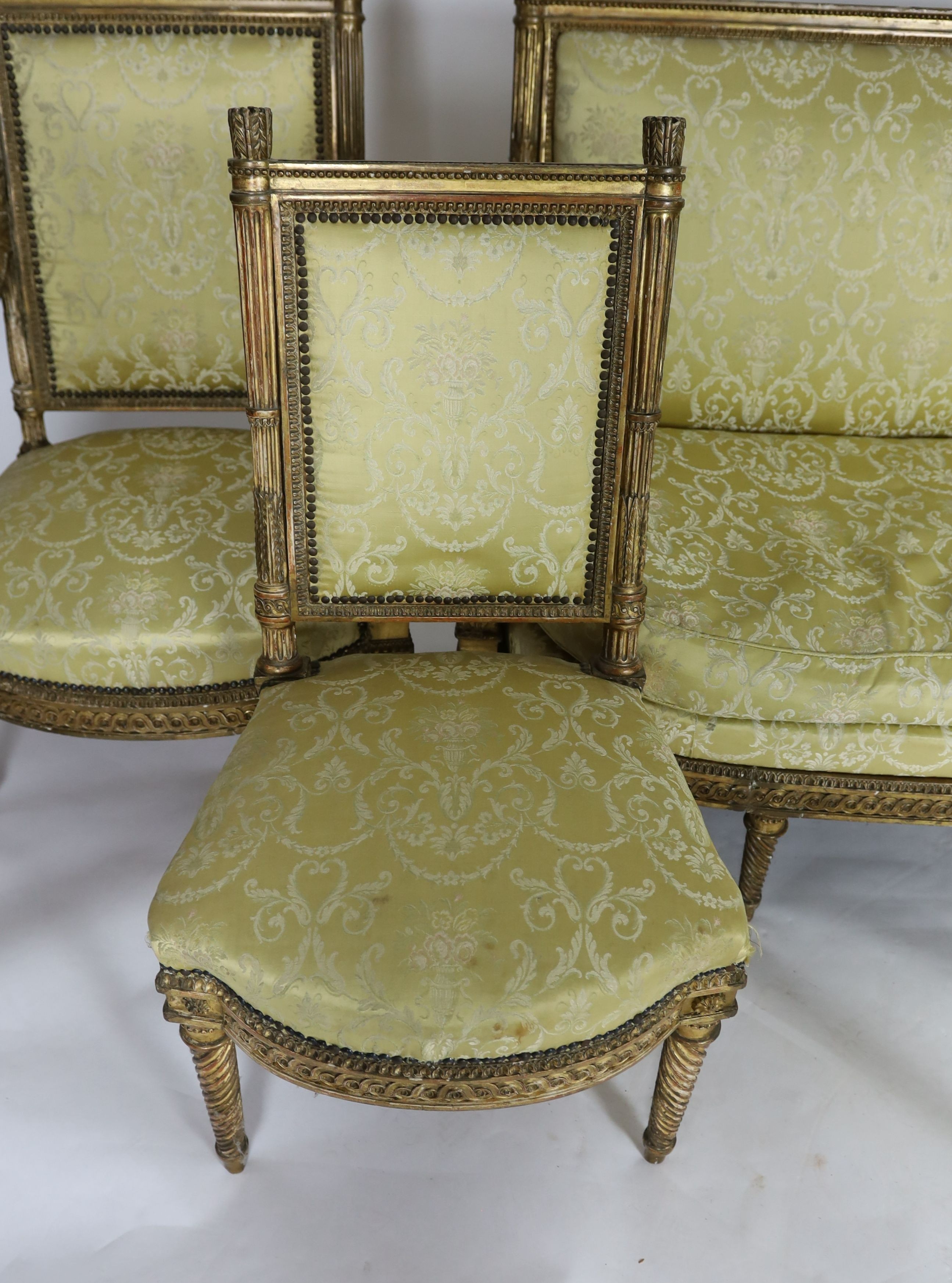 A Louis XVI carved giltwood five piece salon suite, settee W.148cm D.69cm H.100cm